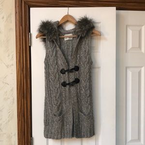 Sweater vest with fur hood